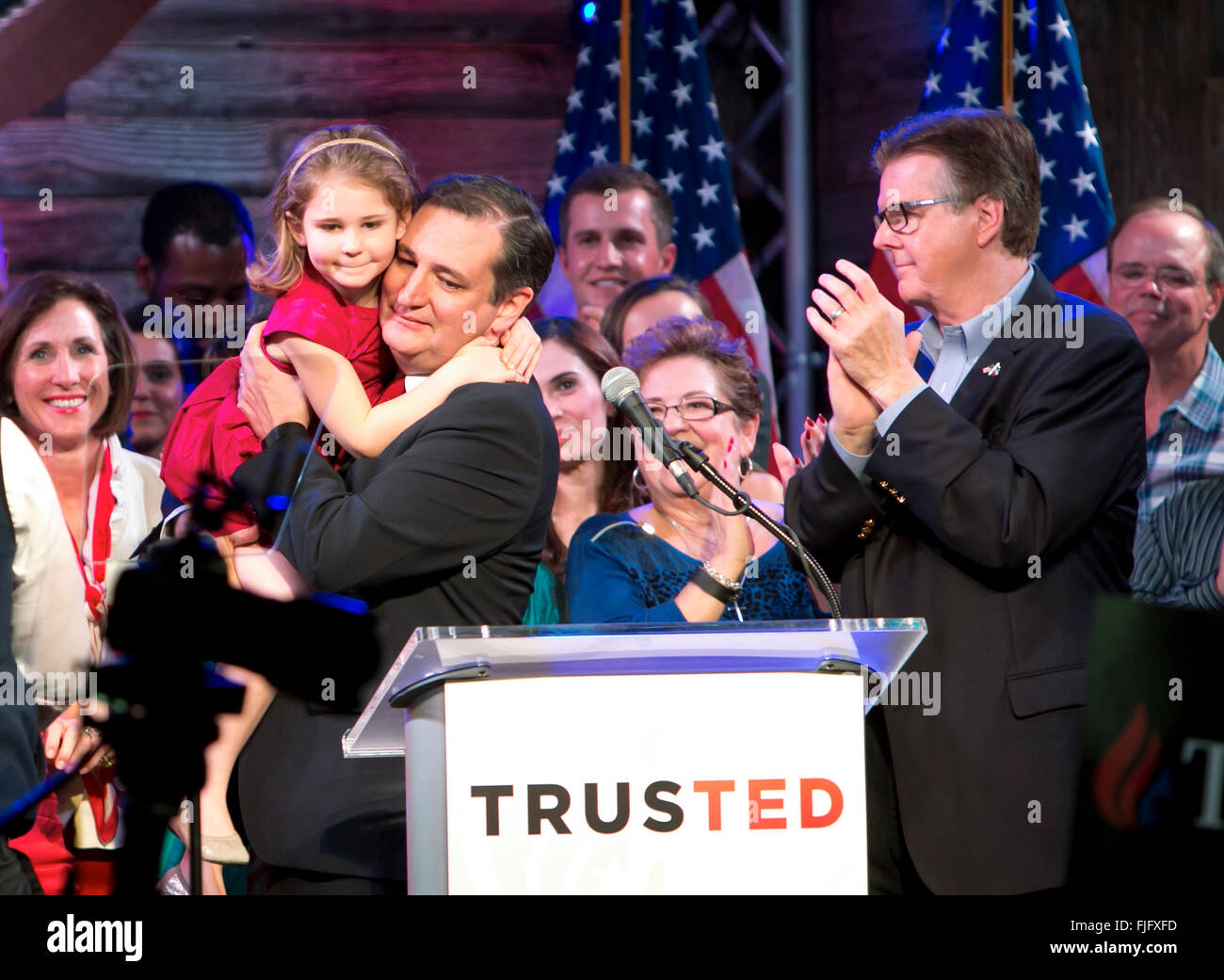 Republican presidential hopeful Ted Cruz holds daughter while savoring victory in the Texas primary election with supporters Stock Photo