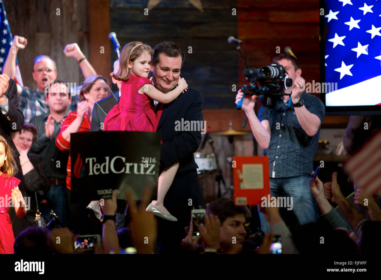 Republican presidential hopeful Ted Cruz holds daughter while savoring victory in the Texas primary election with supporters Stock Photo