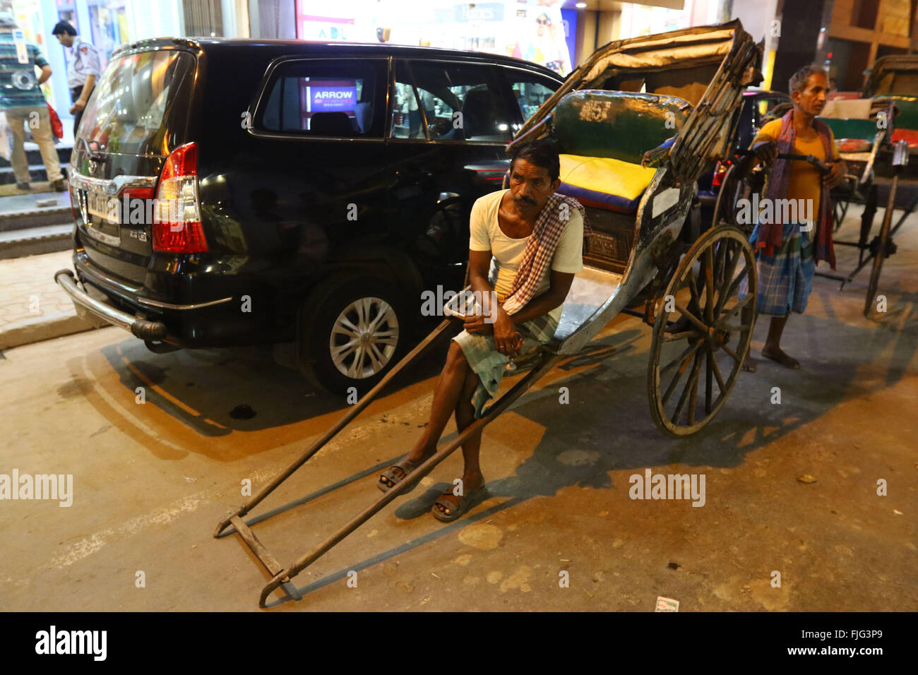 India, 19 February 2016. Hand pulling rickshaw puller waiting for passenger at street of Kolkata. Photo by Palash Khan Stock Photo