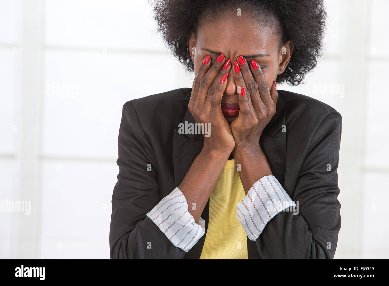 Portrait of mature black woman stressed at work Stock Photo