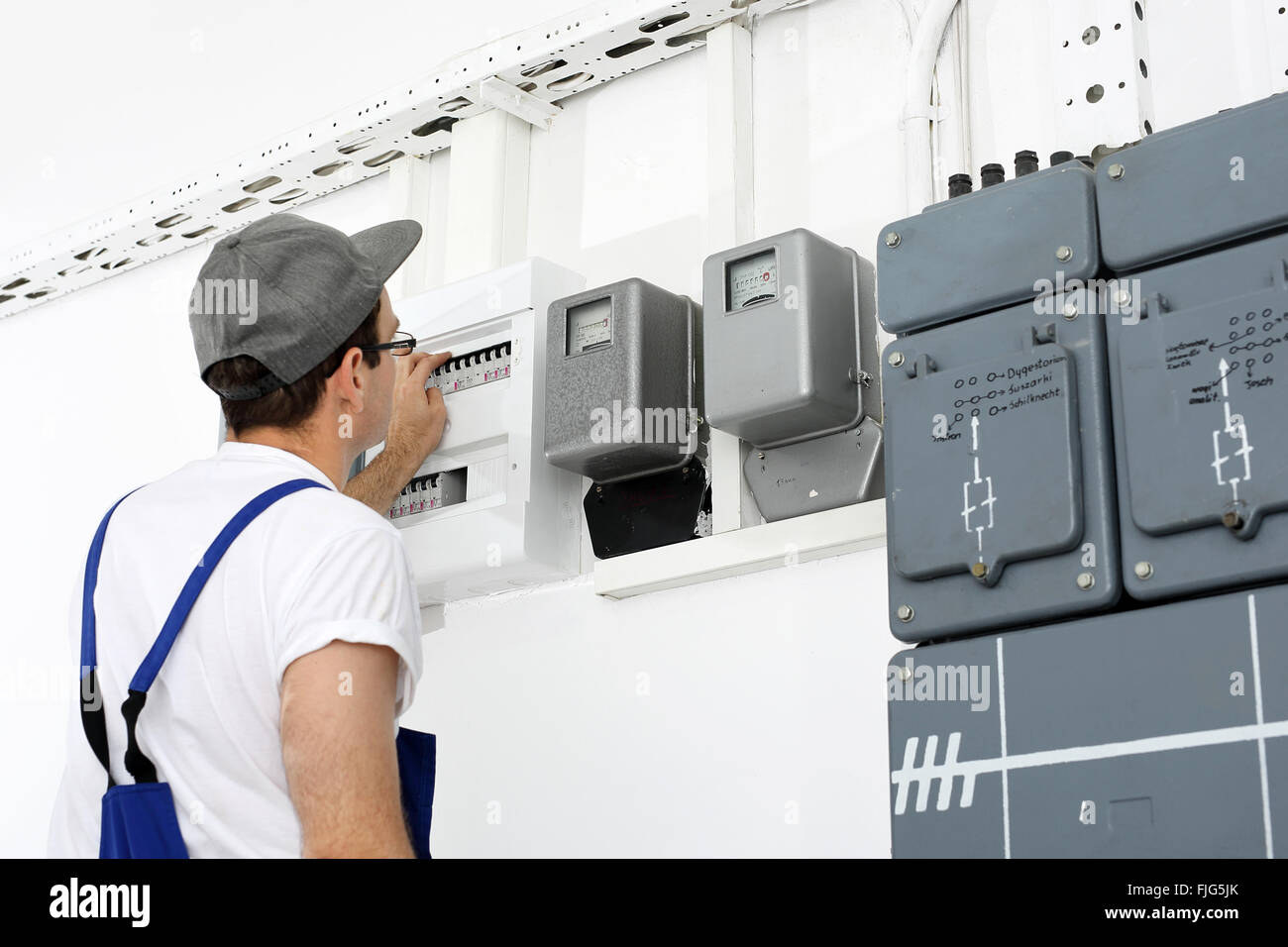 Electrician. Switching current home. Corks, electrical switches on the