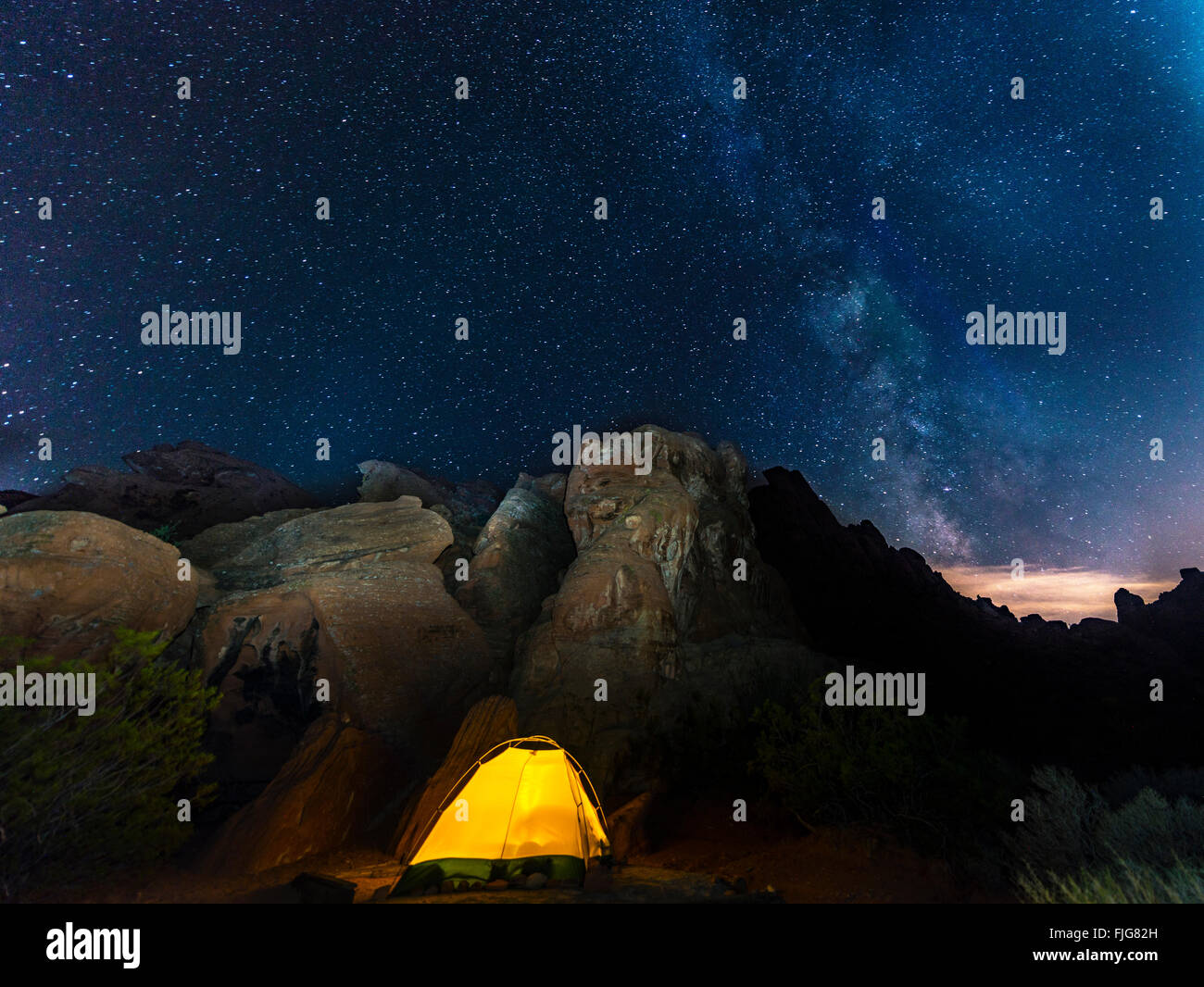 Tent on a campsite with starry sky above and Milky Way, night scene, Wildrose Campground, Death Valley National Park, California Stock Photo