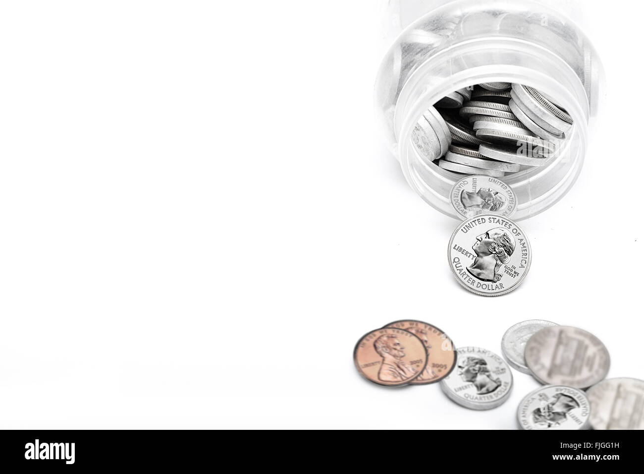 Coins of American currency coming out of Saving Jar. Stock Photo