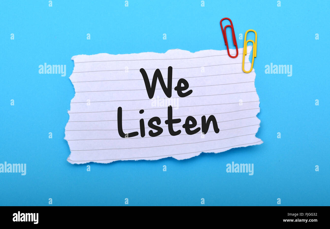 We Listen client services on paper closeup. Stock Photo