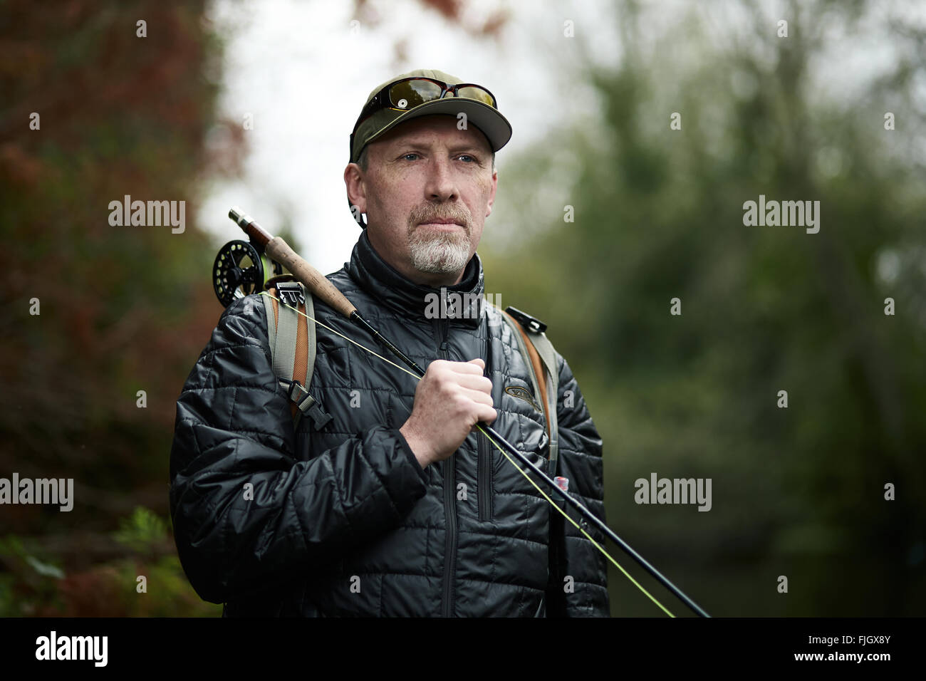 A man fly fishing in a river - London, UK Stock Photo