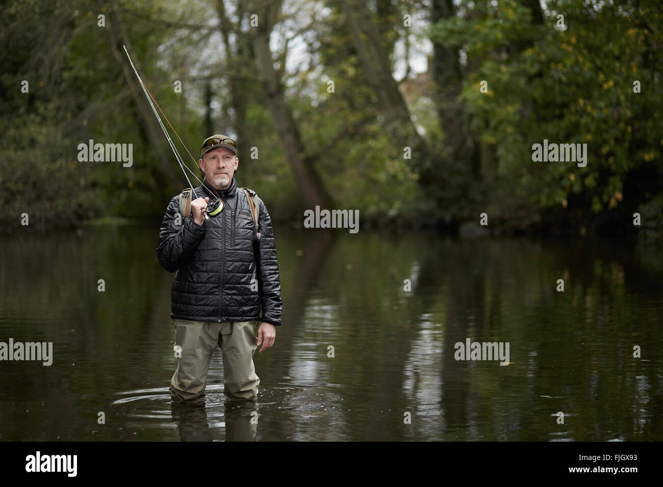 A man fly fishing in a river - London, UK Stock Photo