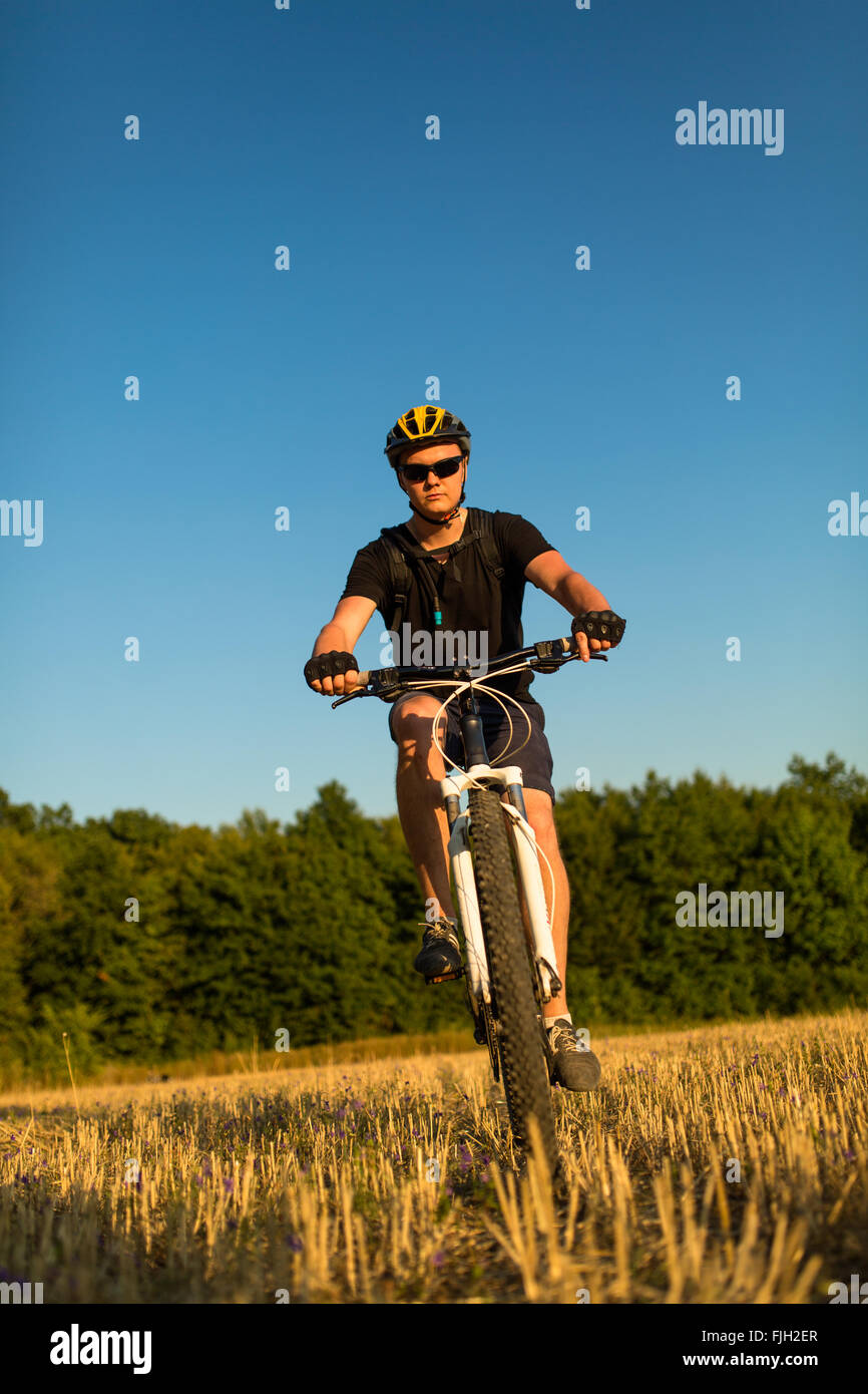 Rider on Mountain Bicycle it the field Stock Photo - Alamy