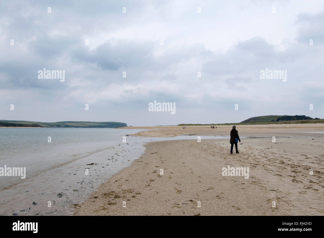 Woman walking along the beach at Rock, Cornwall, UK. Stock Photo