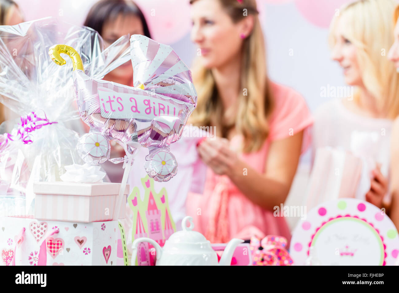 Best Friends on baby shower party celebrating giving kid stuff as present Stock Photo