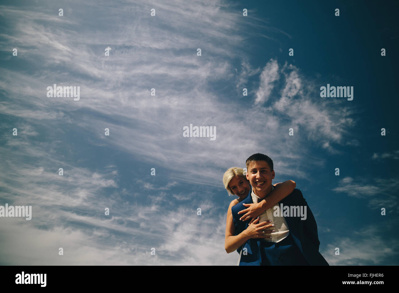 bride and groom on the background of sky Stock Photo - Alamy