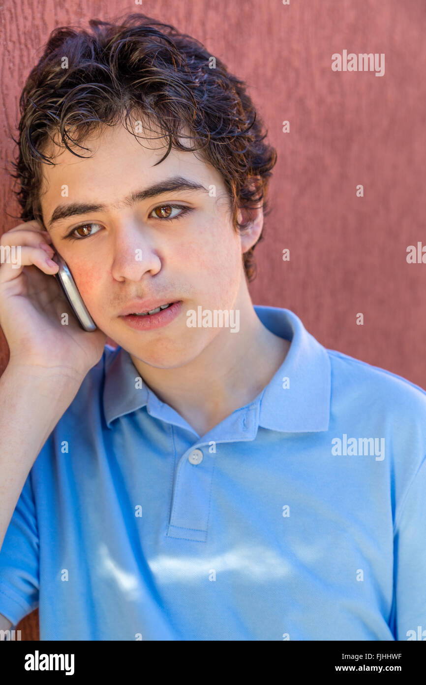 pensive teenager while talking on cell phone Stock Photo