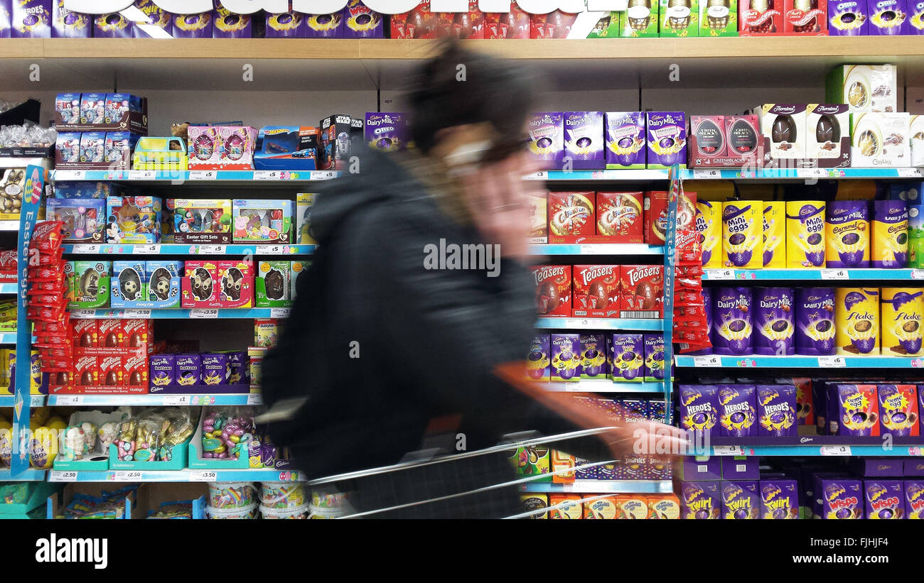 London, UK 2 March 2016 -  A shopper in Sainsburys store passes by the Easter Eggs display.  Sainsbuys store in Harringey, North London start Easter Eggs displays three weeks early. Good Friday is on Friday, 25 March 2016 and Easter Sunday on Sunday, 27 March 2016 © Dinendra Haria/Alamy Live News Stock Photo