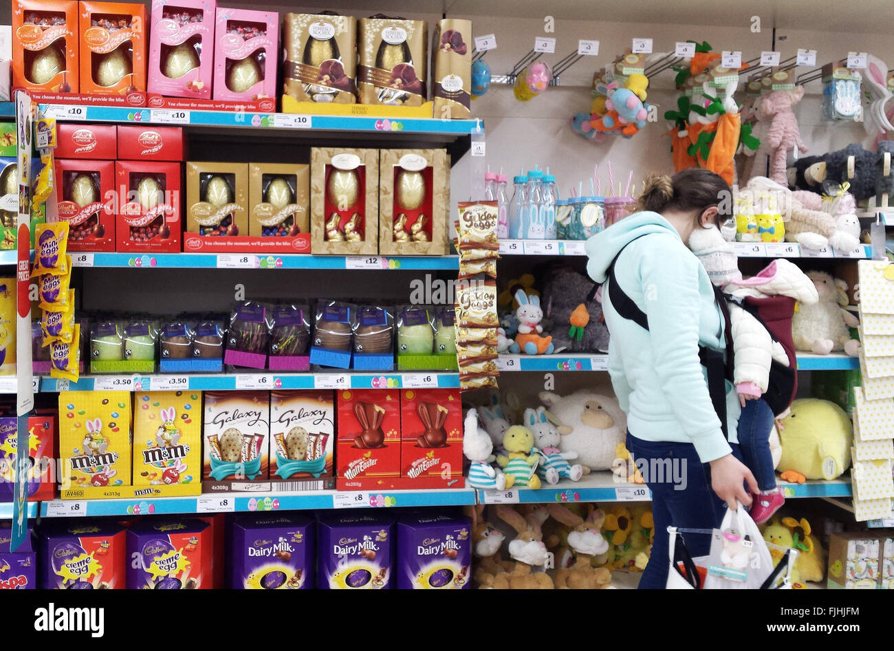 London, UK 2 March 2016 - A shopper in Sainsburys store looks at the Easter goods display. Sainsbuys store in Harringey, North London start Easter Eggs displays three weeks early. Good Friday is on Friday, 25 March 2016 and Easter Sunday on Sunday, 27 March 2016 © Dinendra Haria/Alamy Live News Stock Photo