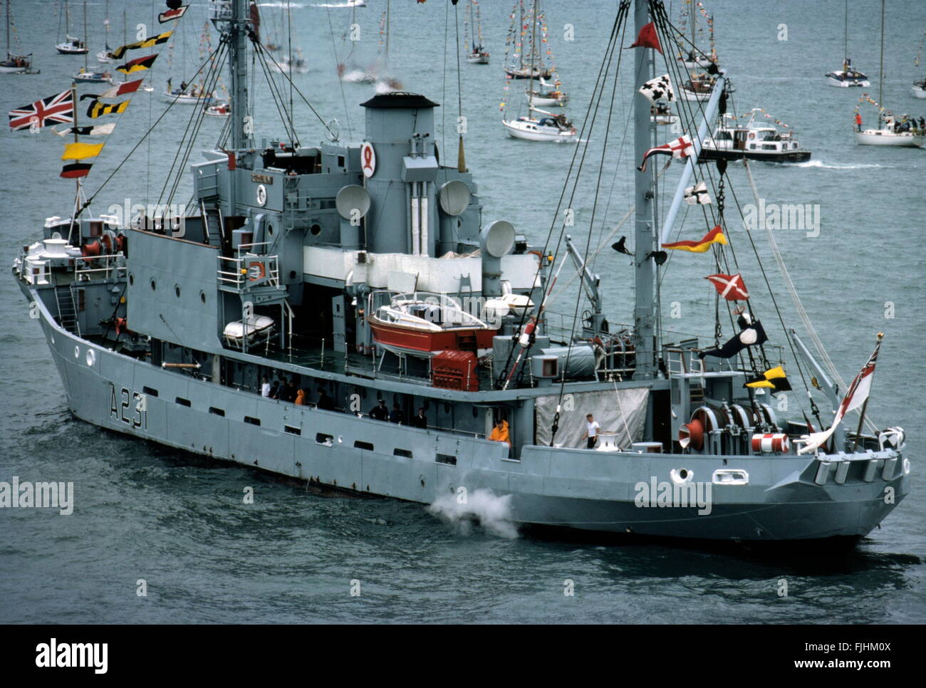 AJAXNETPHOTO. 25TH JUNE, 1977. PORTSMOUTH, ENGLAND. - LAST NAVY SAILING SHIP - H.M.S. RECLAIM, THE ROYAL NAVY'S DIVING SUPPORT SHIP, LEAVING HARBOUR TO TAKE UP HER SILVER JUBILEE FLEET REVIEW POSITION AT SPITHEAD.   PHOTO:JONATHAN EASTLAND/AJAX  REF:909234. Stock Photo