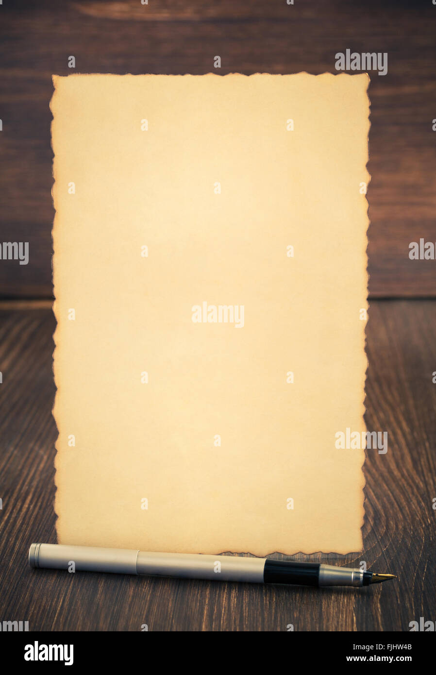 paper vintage parchment on wooden background Stock Photo - Alamy