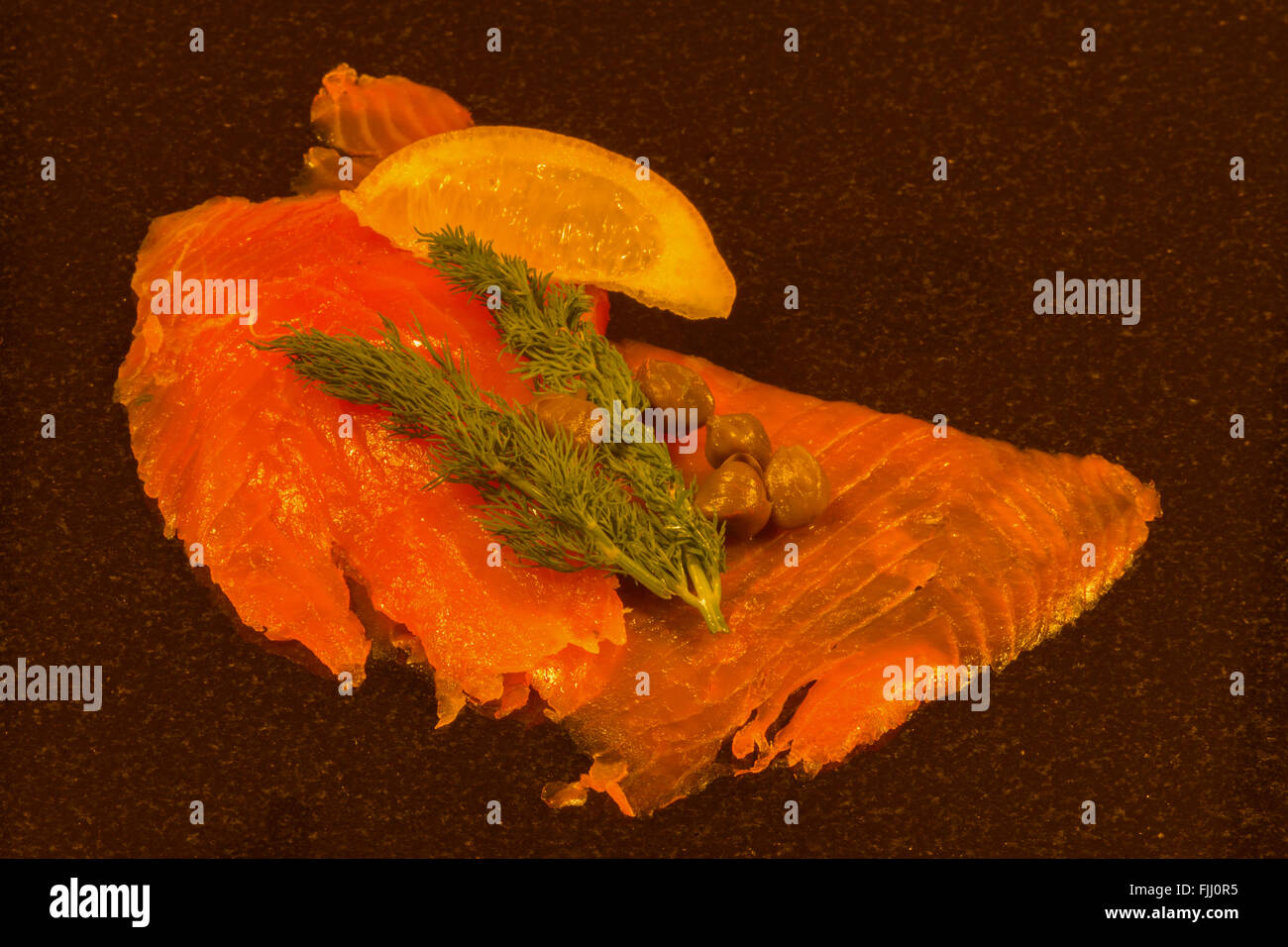 Smoked salmon with capers, dill and lemon Stock Photo - Alamy
