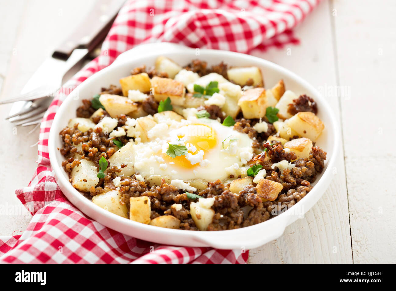 Potato hash with sausage and fried egg Stock Photo Alamy