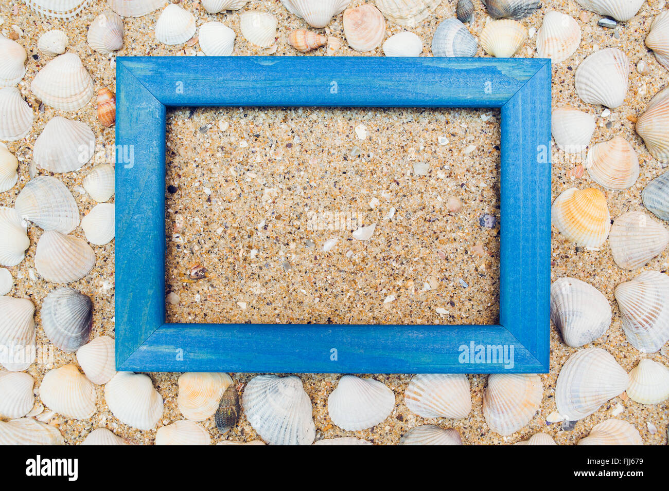 Travel background with frame on sand Stock Photo