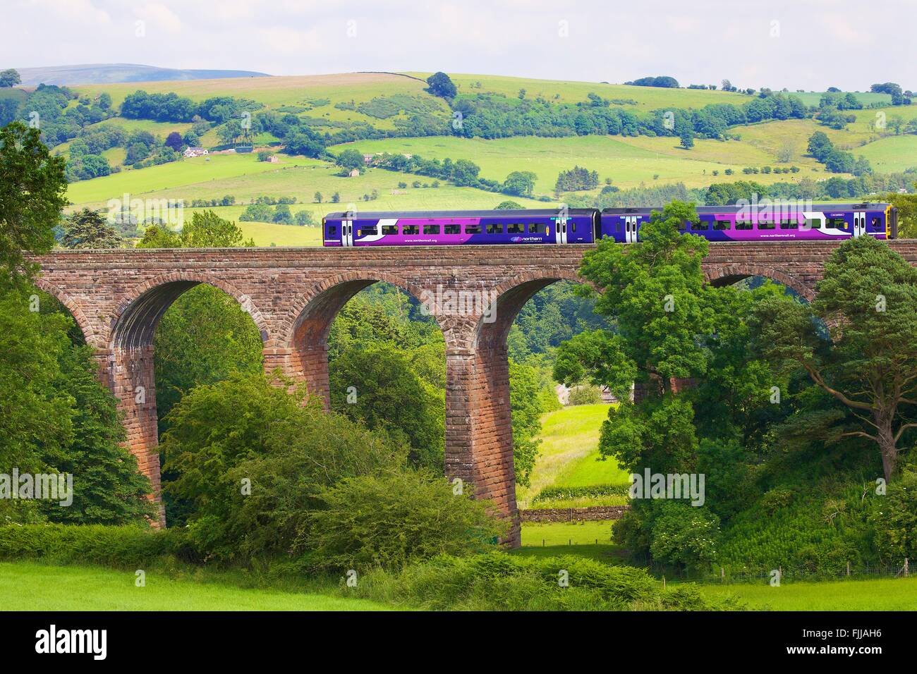 Settle to Carlisle Railway Line. Sprinter passenger diesel train passing over Dry Beck Viaduct, Eden Valley, Cumbria, England. Stock Photo