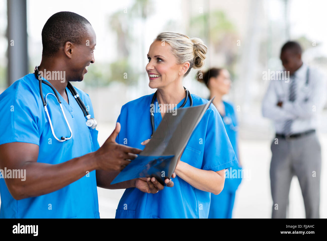 medical doctors discussing over x-ray in hospital Stock Photo