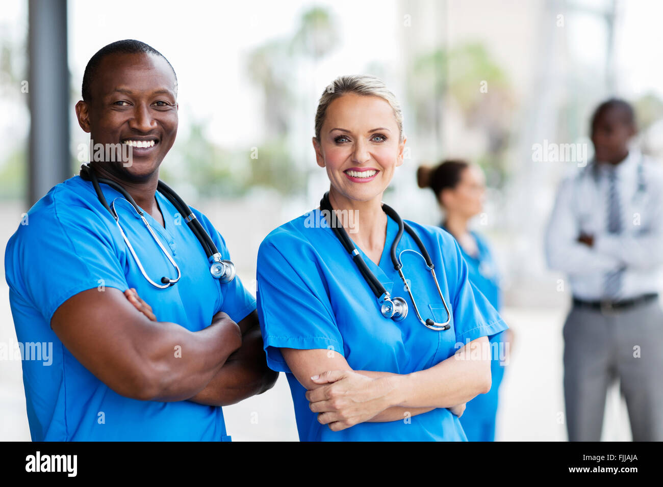 portrait of happy medical co-workers arms crossed Stock Photo