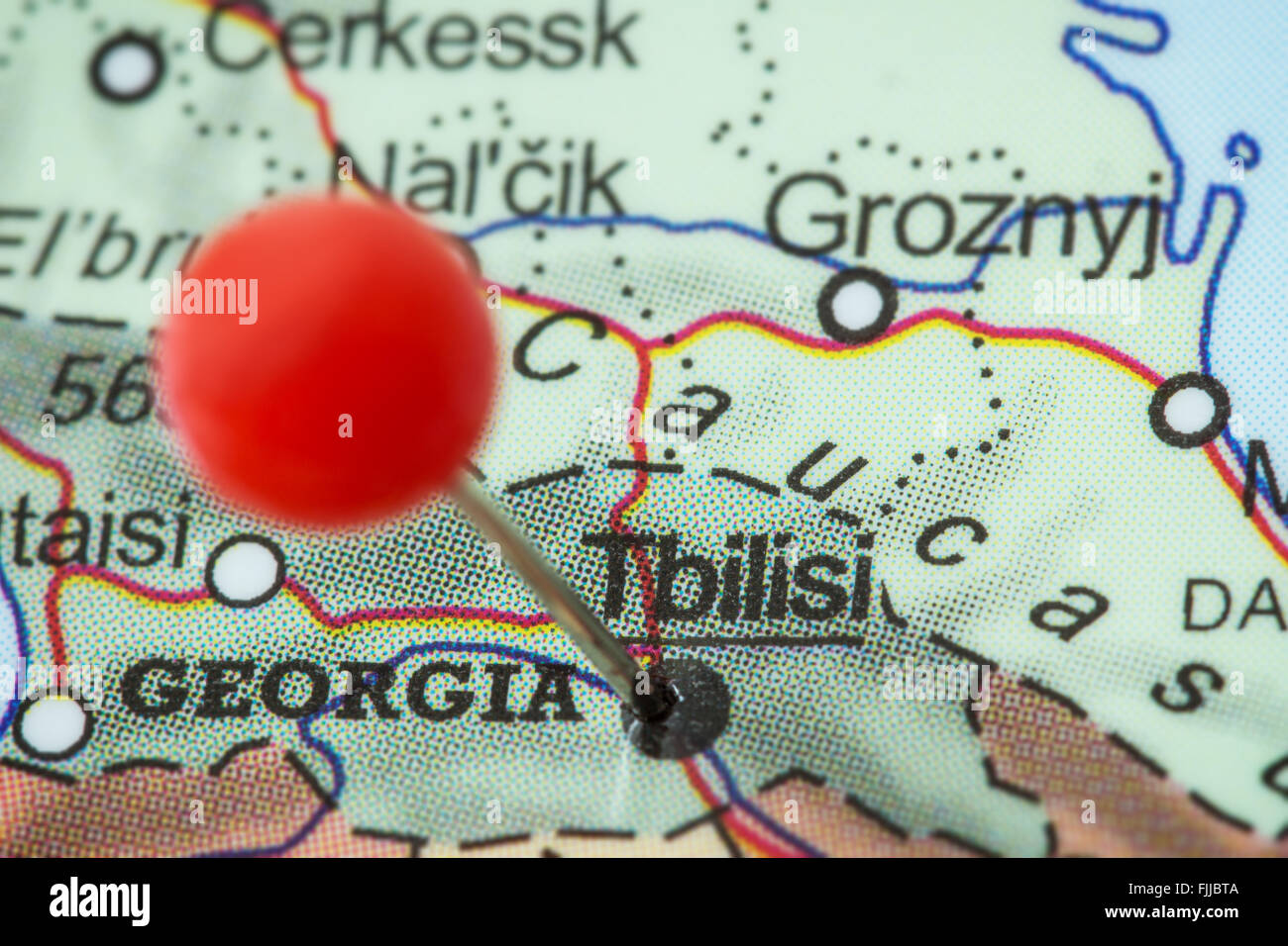 Close-up of a red pushpin in a map of Tbilisi, Georgia. Stock Photo