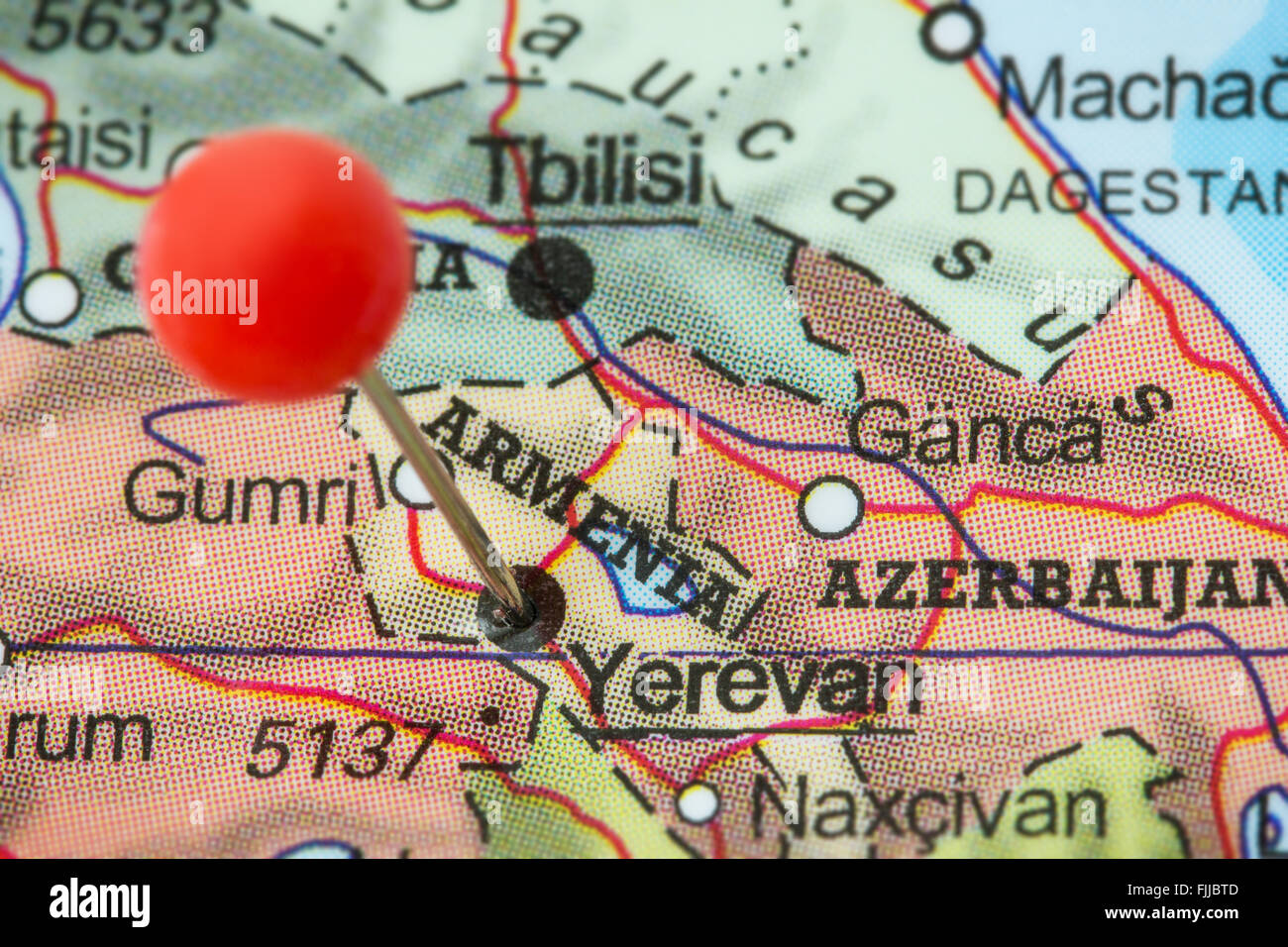 Close-up of a red pushpin in a map of Yerevan, Armenia. Stock Photo