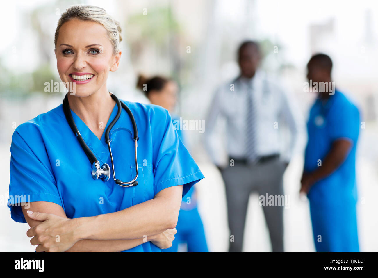 confident mid age medical doctor in hospital Stock Photo