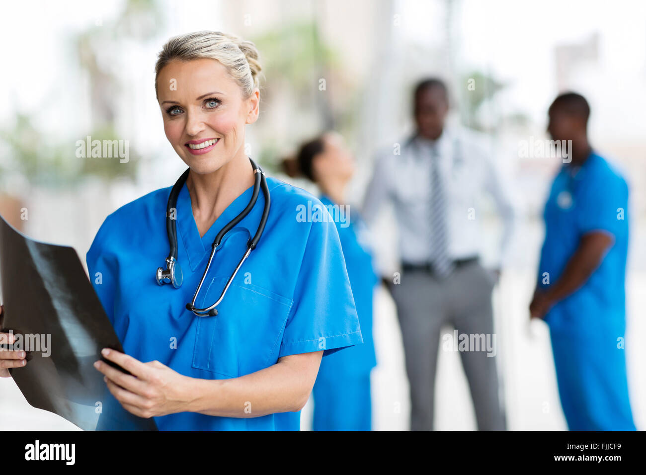 beautiful female doctor holding CT scan in office Stock Photo