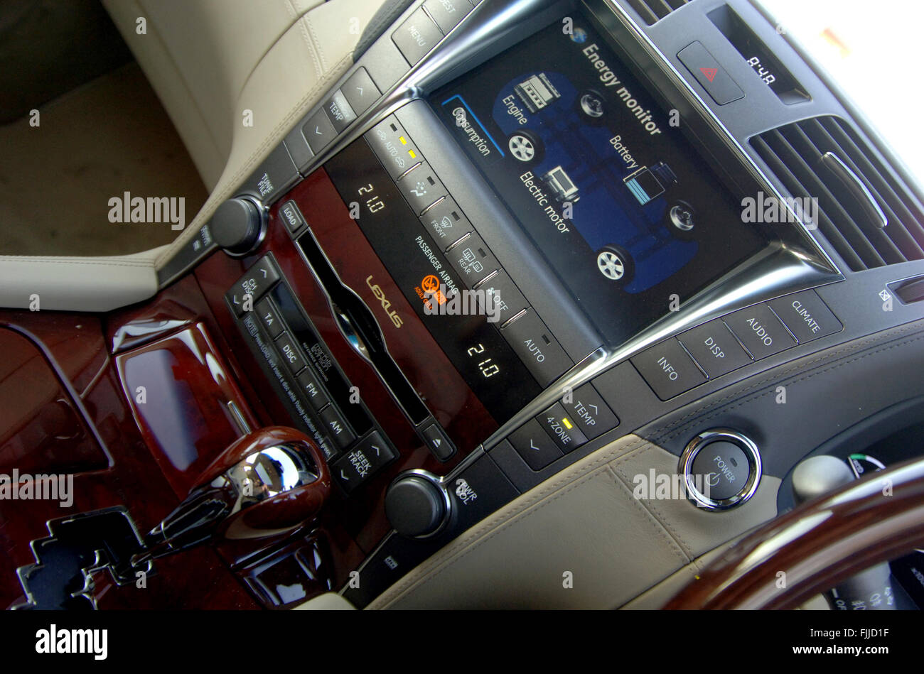 Hybrid car dashboard screen showing an energy monitor of engine and battery use Stock Photo