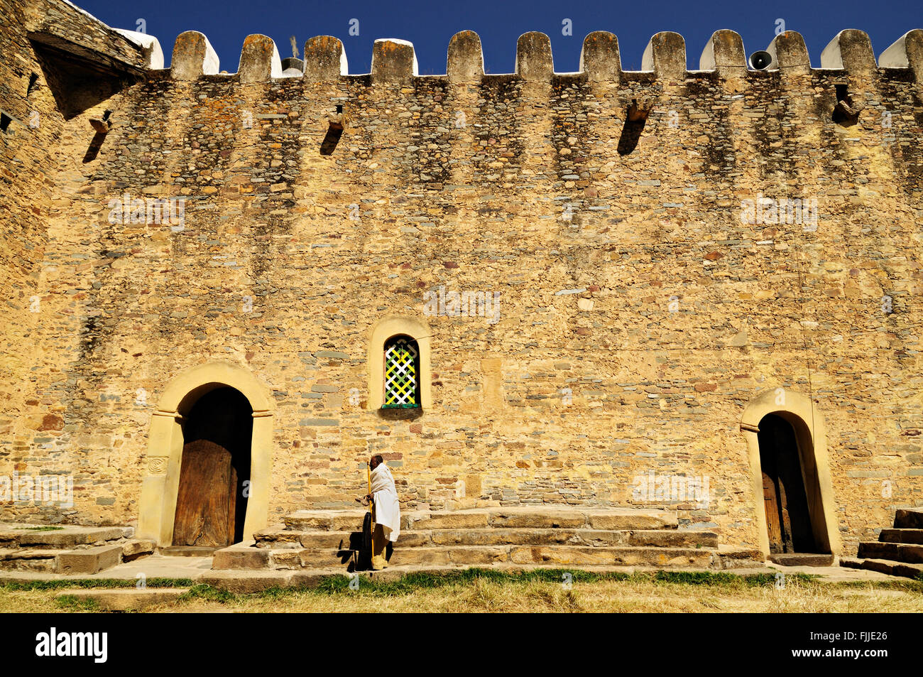 Man in white in front of the old Church of Our Lady Mary of Zion in Axum (or Aksum), Tigray Region, Ethiopia Stock Photo