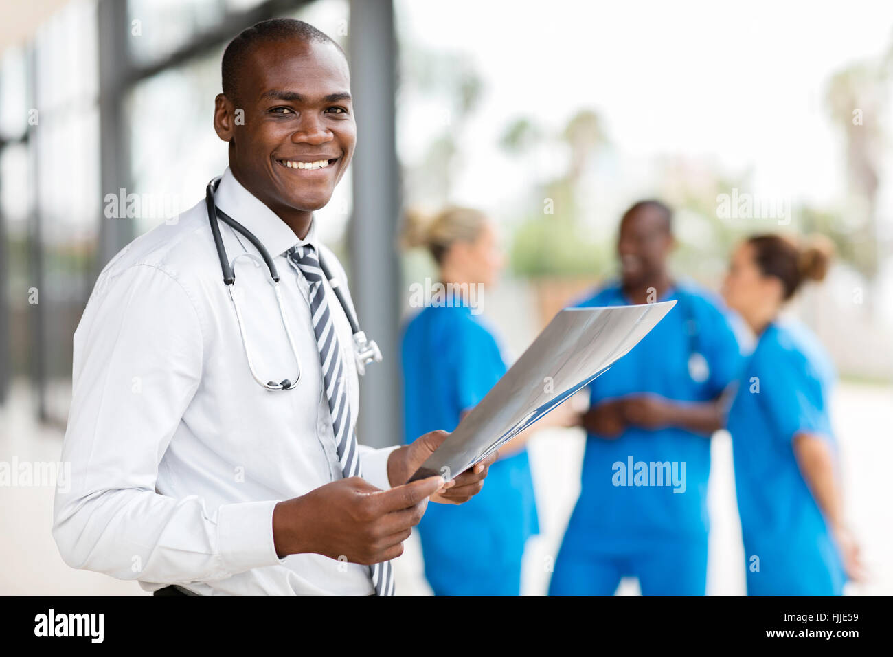 portrait of young African hospital doctor holding patient's x-ray Stock Photo