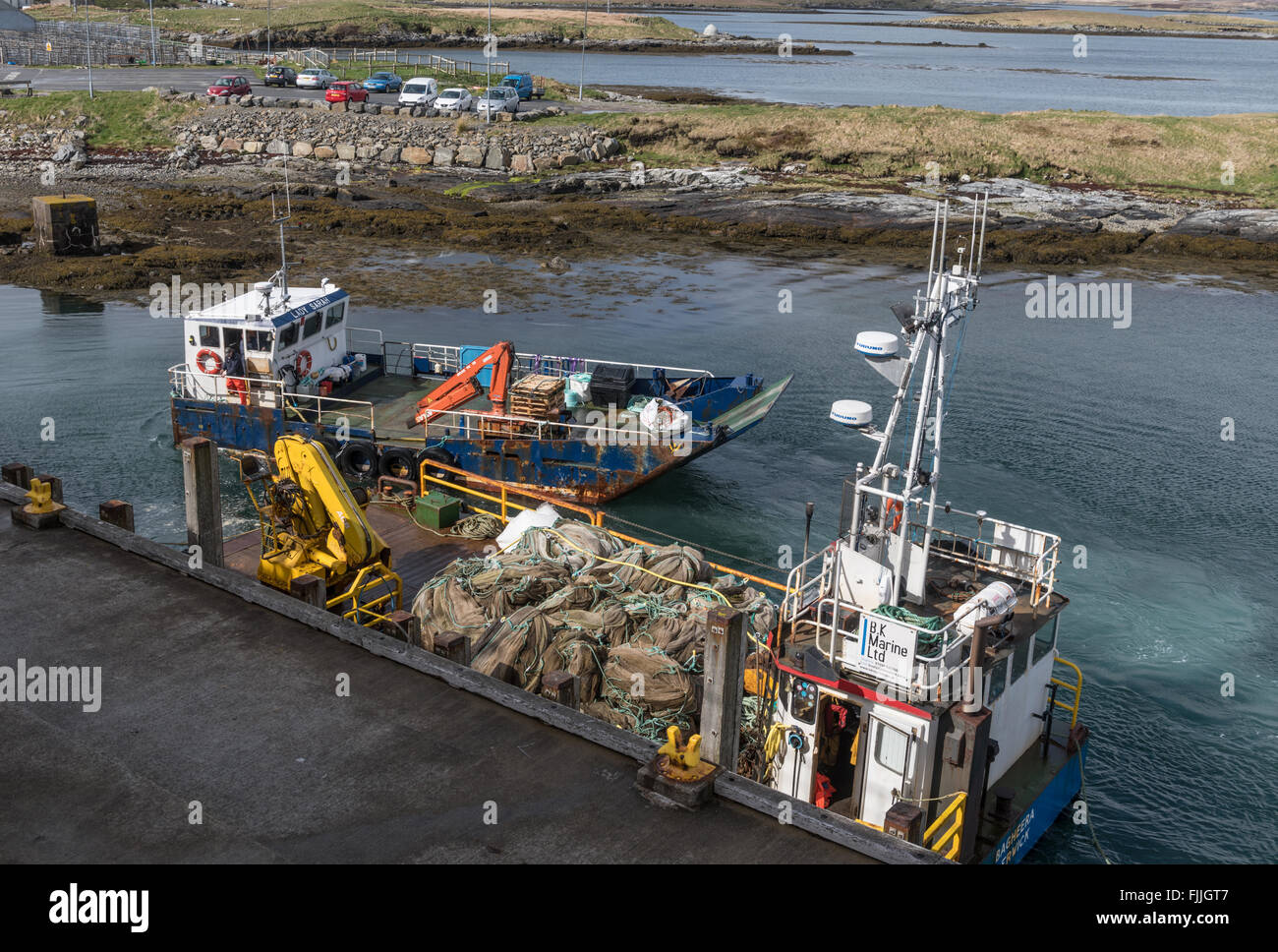 Fish farm supply vessels at Lochmaddy Pier on North Uist Stock Photo