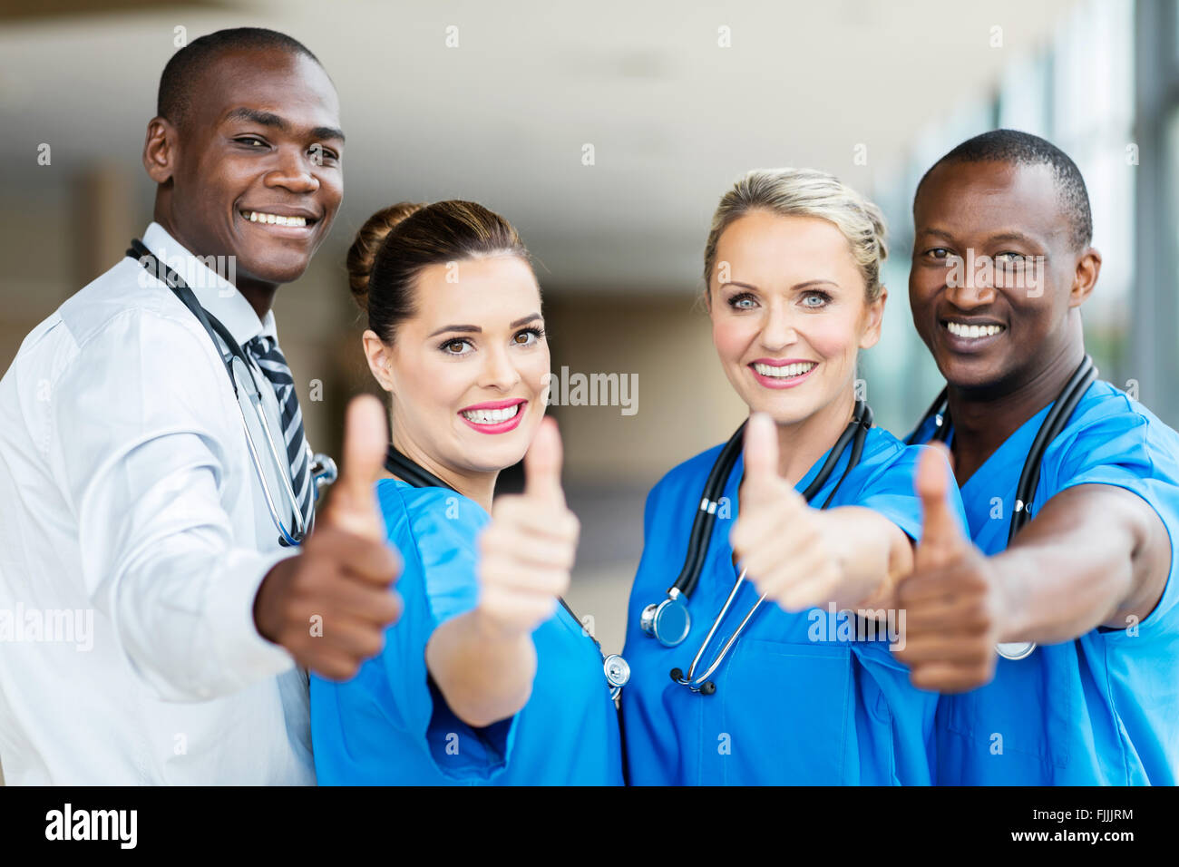 group of modern healthcare workers thumbs up Stock Photo