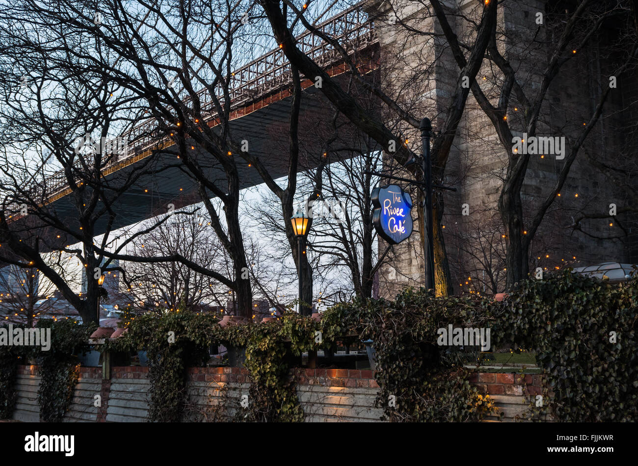 The garden on the River Cafe in DUMBO, Brooklyn sits underneath the Brooklyn Bridge. Stock Photo