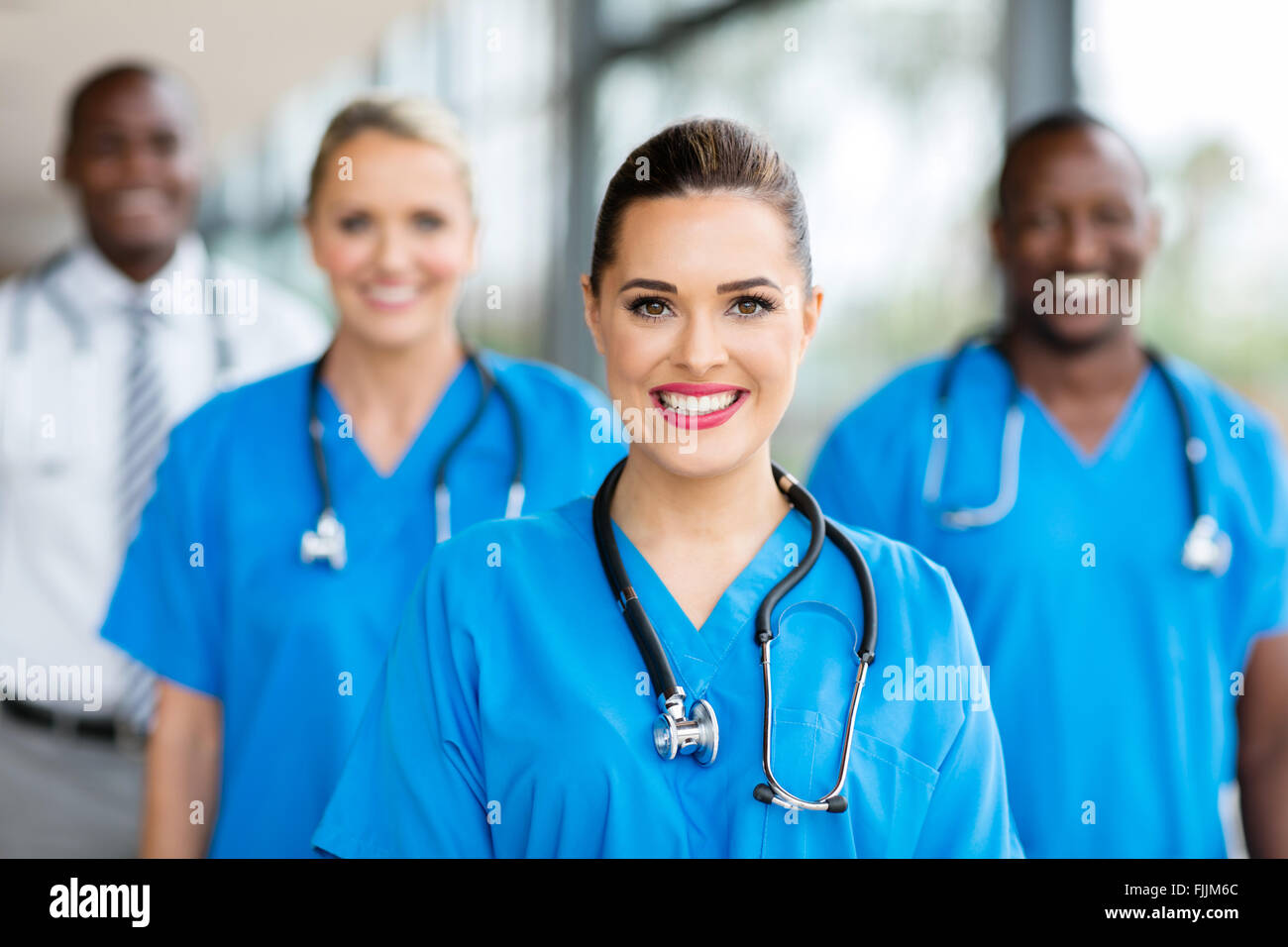 pretty medical nurse and colleagues in hospital Stock Photo