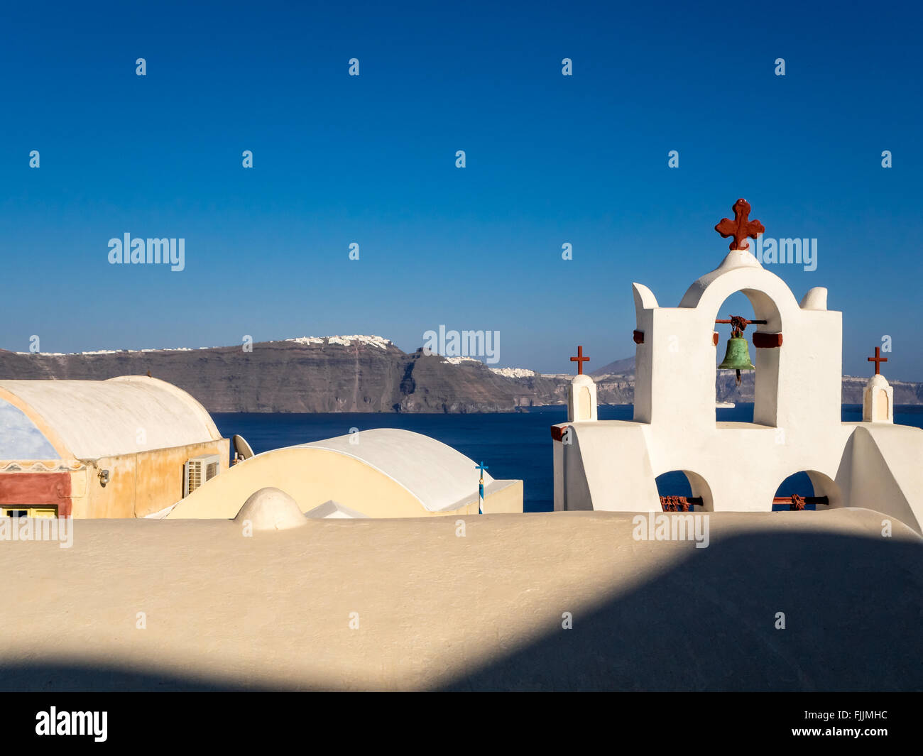 Characteristic view of the famous town of Thira on the island of  Santorini and the bell tower of the old Greek church. Stock Photo
