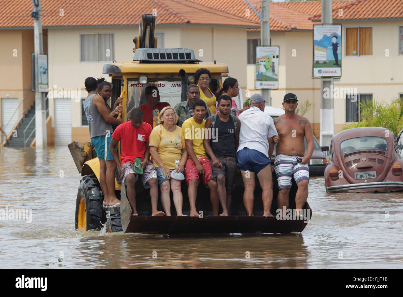 Marica, Brazil. 2nd Mar, 2016. Residents are transported by a bulldozer through flood in Itaipuacu district, Marica city, Rio de Janeiro state, Brazil, on March 2, 2016. Residents in different parts of Itaipuacu district remain stranded after the 24-hour heavy rains. Credit:  Paulo Campos/AGENCIA ESTADO (jg/Xinhua/Alamy Live News Stock Photo