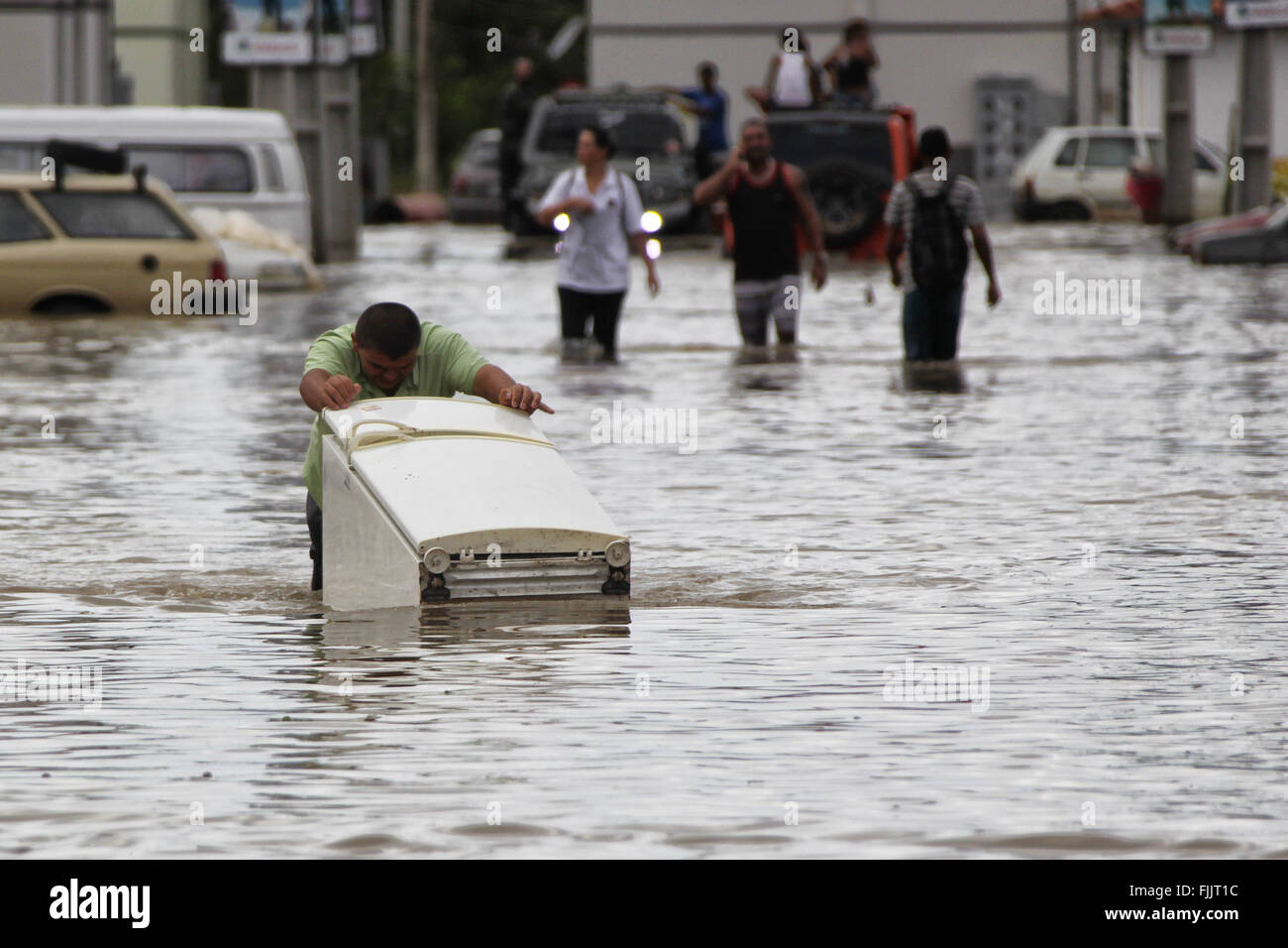 Marica, Brazil. 2nd Mar, 2016. Residents walk through flood in Itaipuacu district, Marica city, Rio de Janeiro state, Brazil, on March 2, 2016. Residents in different parts of Itaipuacu district remain stranded after the 24-hour heavy rains. Credit:  Paulo Campos/AGENCIA ESTADO (jg/Xinhua/Alamy Live News Stock Photo