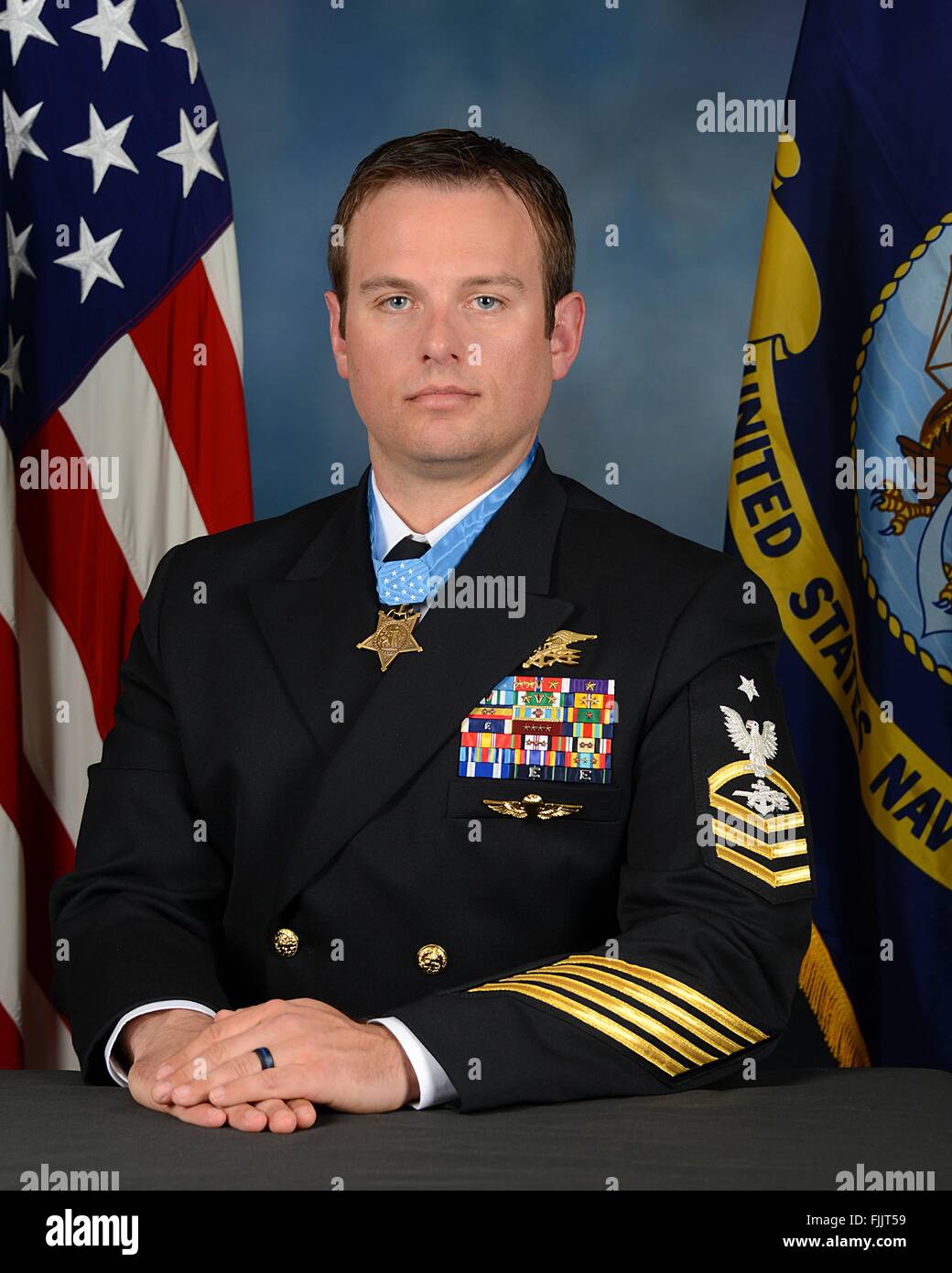 U.S. Navy SEAL Senior Chief Special Warfare Operator Edward Byers official portrait in dress uniform with the Medal of Honor at the Pentagon March 1, 2016 in Washington, DC. Byers, a member of SEAL Team Six was awarded the medal for his role in rescuing an American civilian being held hostage by Taliban insurgents in Afghanistan during a White House ceremony February 29, 2016. Stock Photo