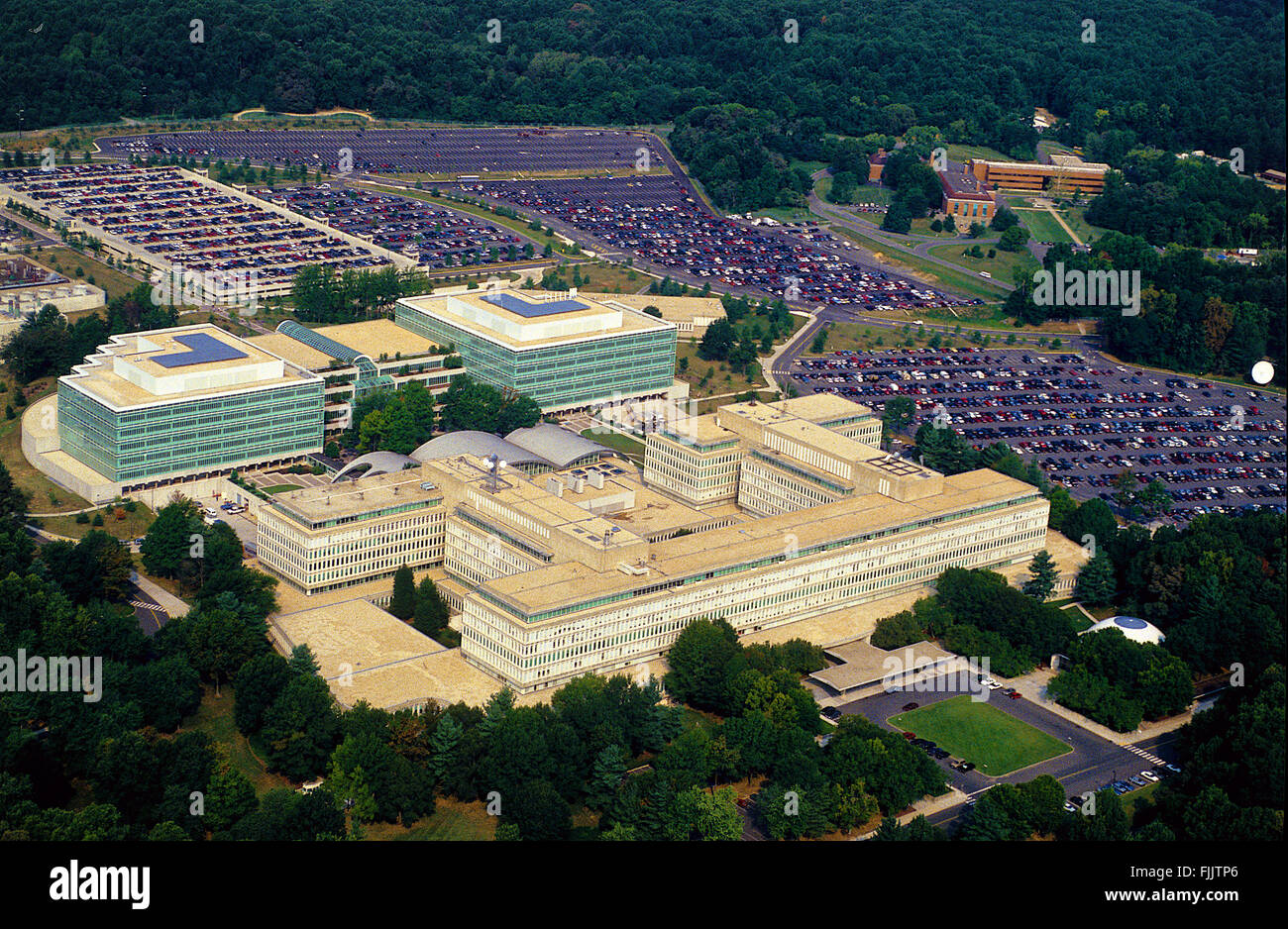 McLean, Virginia, USA, 1991 Aerial view of the CIA headquarters buildings in McLean, Virginia a few miles west of Washington DC. The Central Intelligence Agency (CIA) is one of the principal intelligence gathering agencies of the United States federal government. It's employees operate from U.S. embassies and many other locations around the world. The only independent U.S. intelligence agency, it reports to the Director of National Intelligence.The CIA has three traditional principal activities, which are gathering information about foreign governments, corporations. Credit: Mark Reinstein Stock Photo