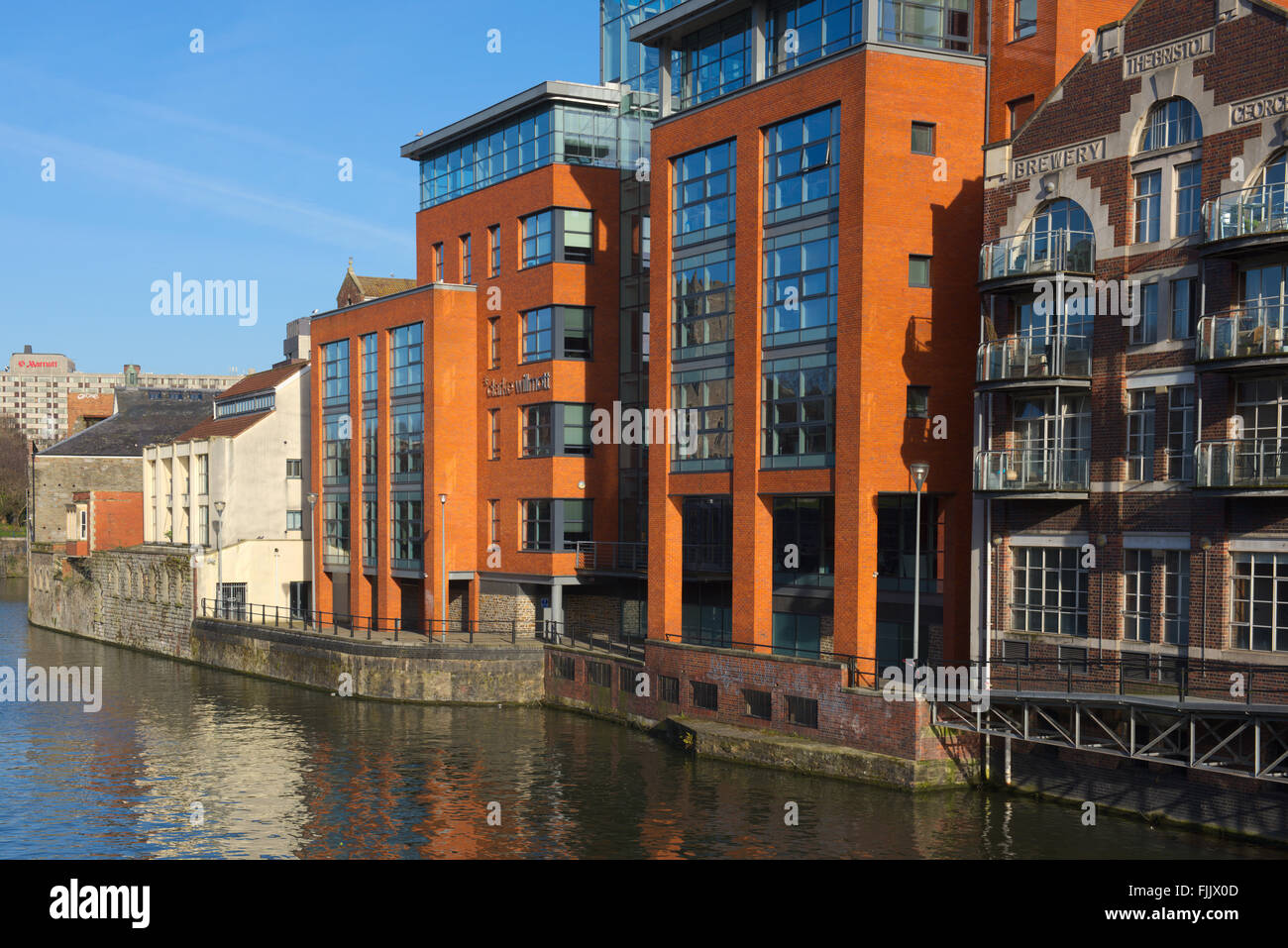 View of Modern apartments built in old industrial building along waterfront of ...