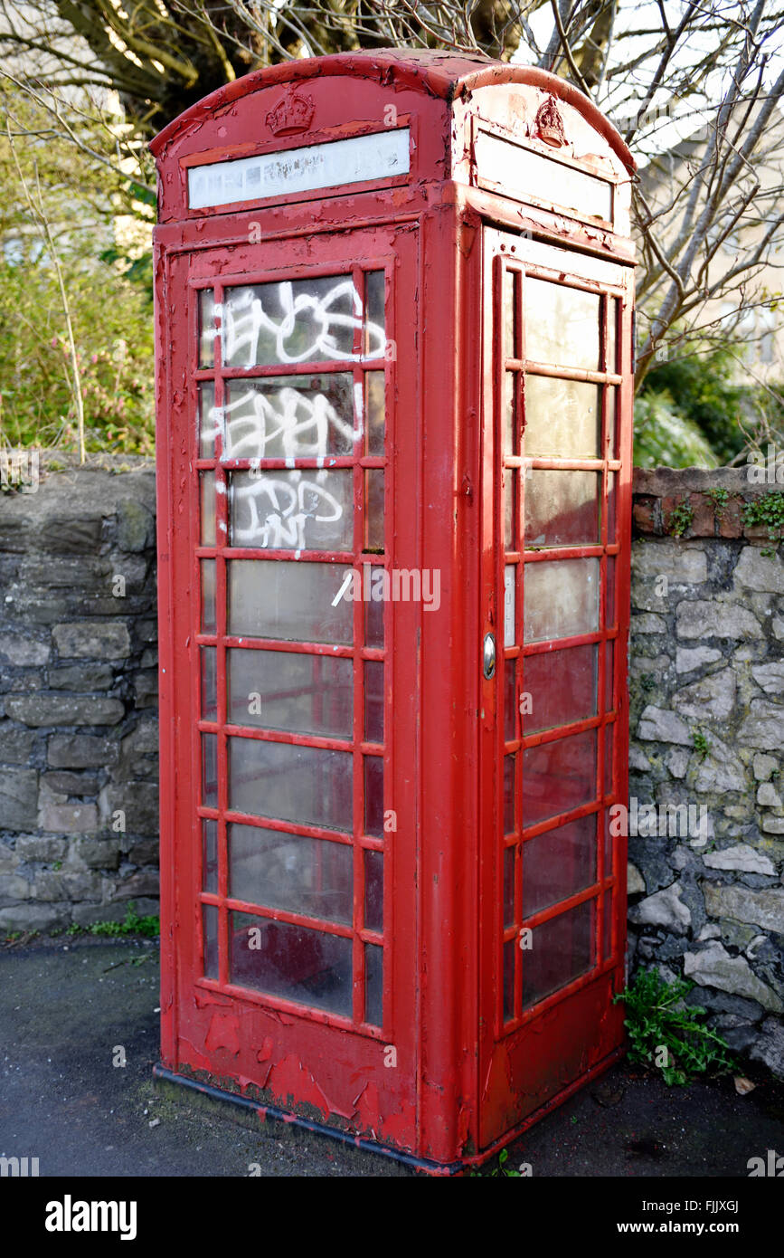 BT red telephone box scruffy and with tagging in Bristol, UK Stock Photo
