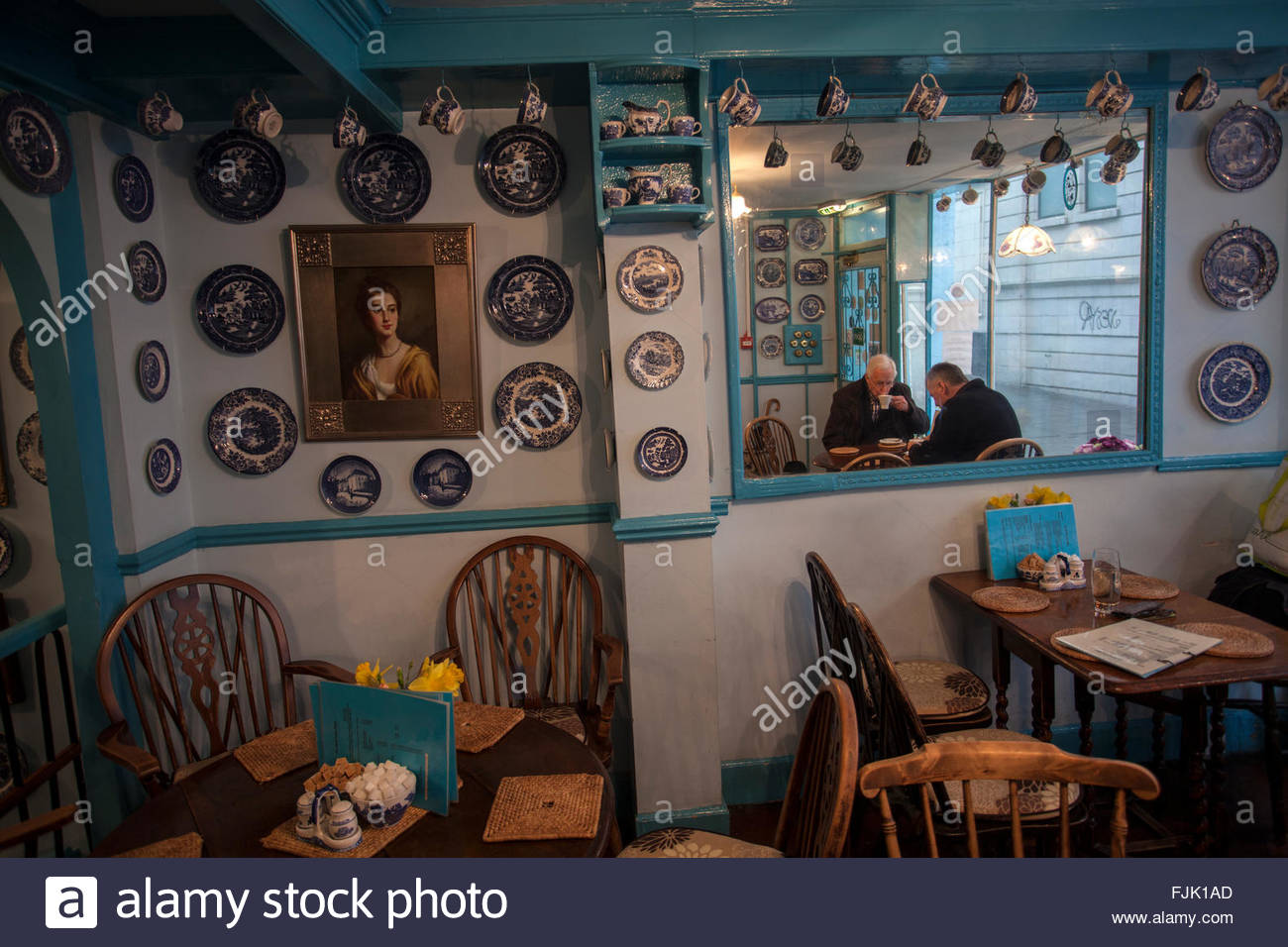 Two Men Take Tea In The Mock Turtle Tea Shop Charming Decor Blue