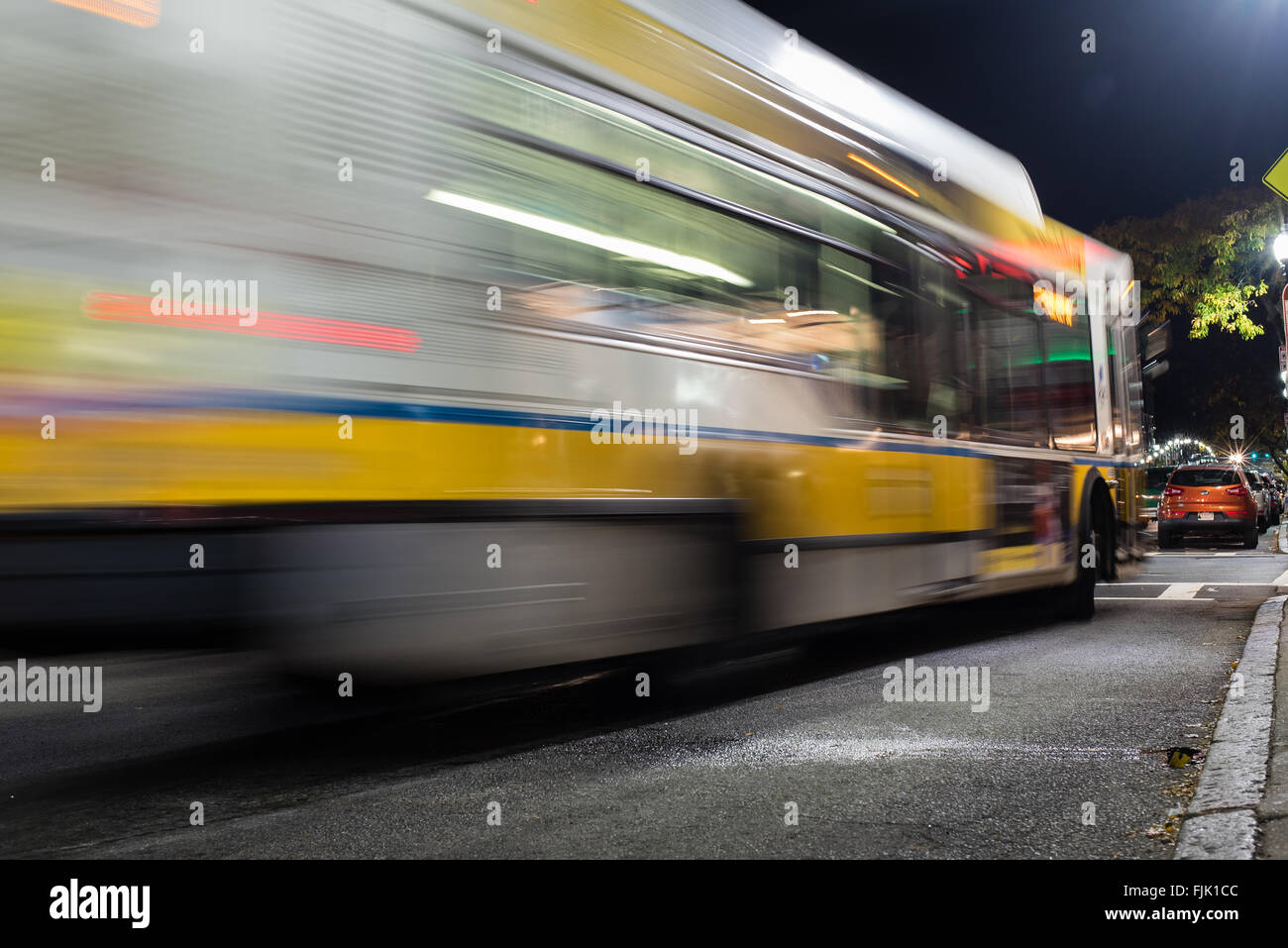 A bus pulling into the stop on a city street in Boston Stock Photo