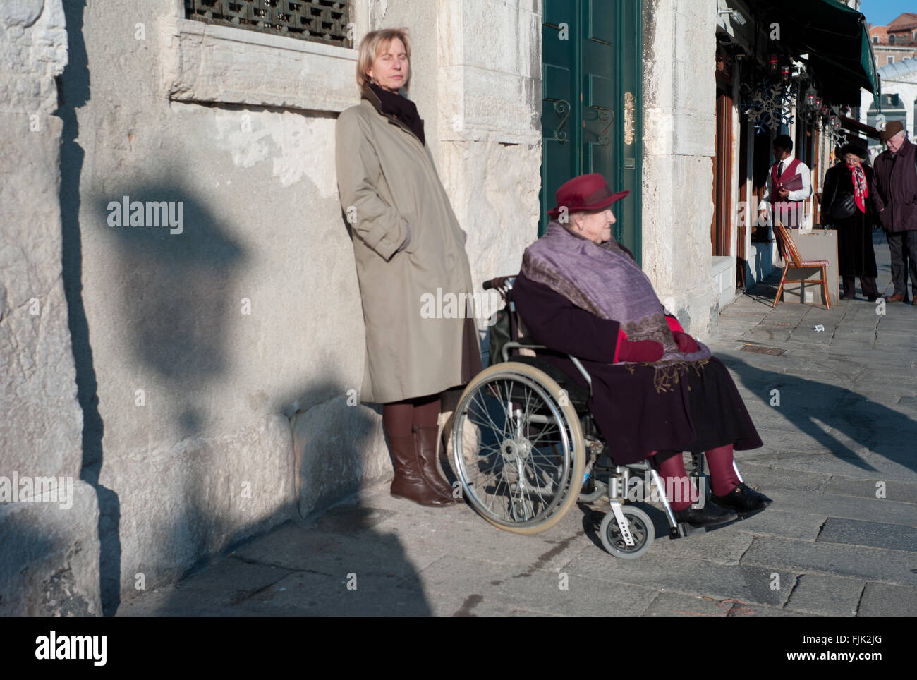 Venice senior people using wheelchair in a city fully surrounded by water Stock Photo