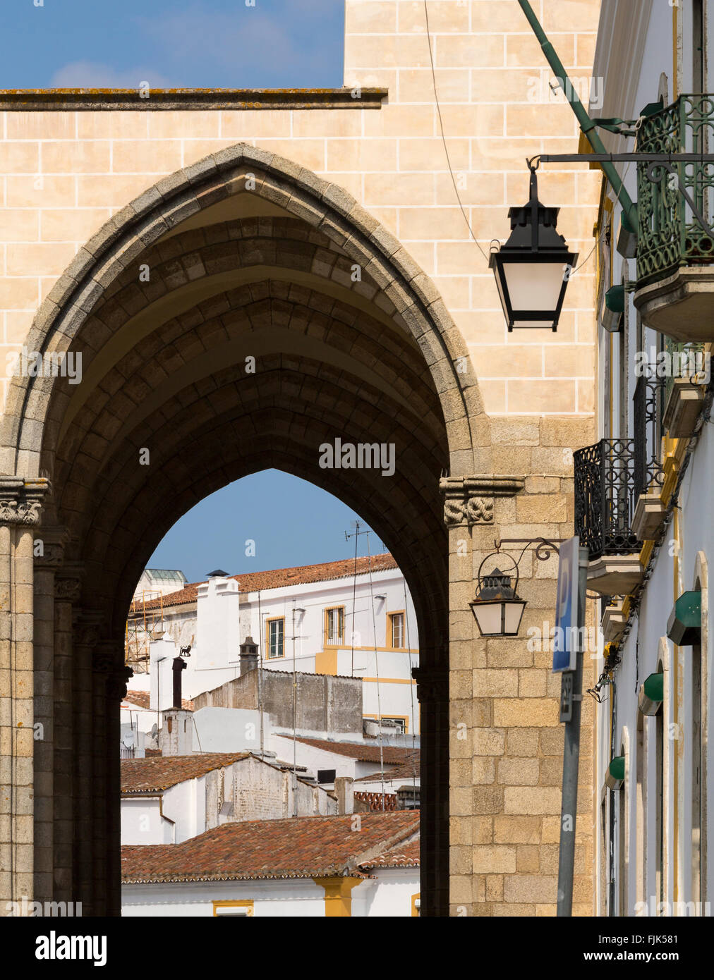 Typical architecture and view of town through archway, Evora, Alentejo region, Portugal Stock Photo