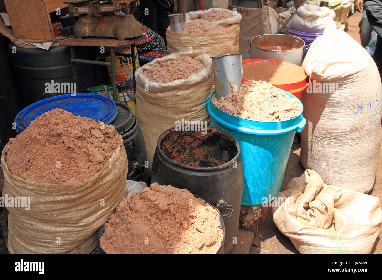 Bags of ground peanuts for peanut butter in an open air market in Africa Stock Photo
