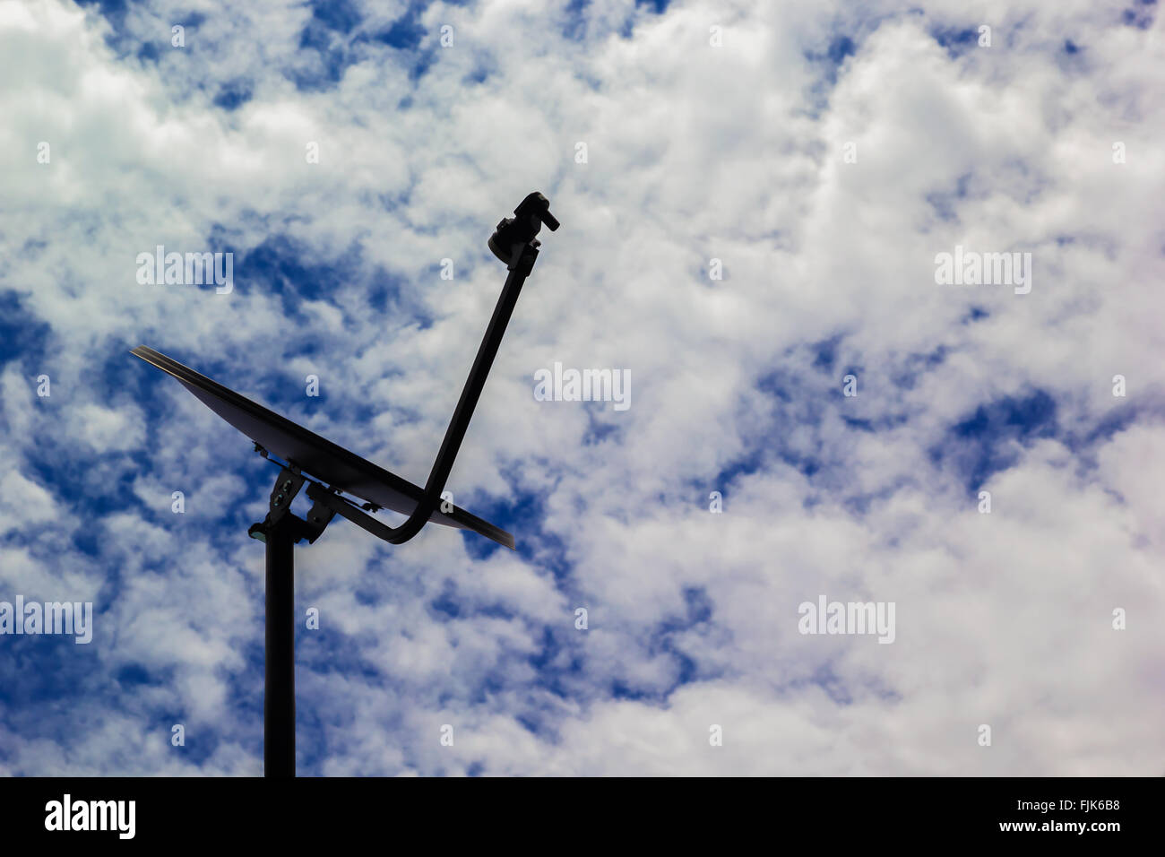 A photo of Satellite dish on Blue sky background Stock Photo