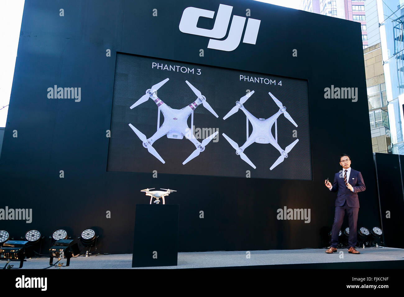 Allen Wu, DJI Japan General Manager, introduces the new Phantom 4 that can dodge obstacles and track objects in Roppongi Hills, on March 3, 2016, Tokyo, Japan. DJI's new model integrates a set of stereo cameras and proximity sensors that work with a computer software vision, which allows the Phantom 4 to fly autonomously. The new generation drone includes two newly added features, the ActiveTrack to continuously record a moving object and TapFly that allows users to select waypoints by controlling their smartphone or tablet. The Phantom 4 includes an Obstacle Sensing System that allows avoidin Stock Photo